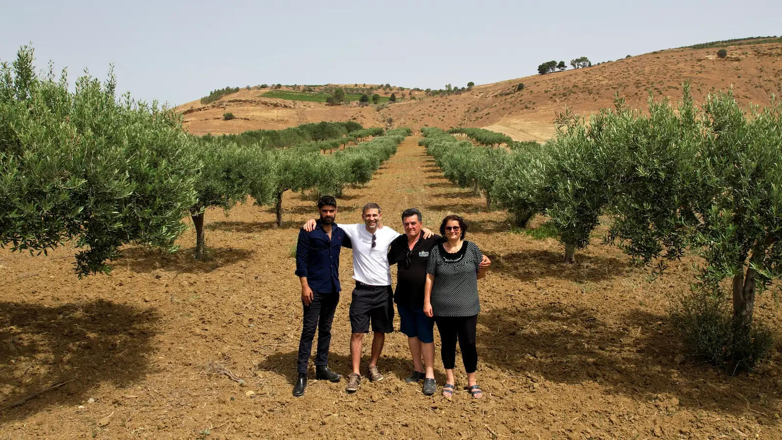 The Castruriali team with Francesco and Maria Concetta Monte among the olive trees on their farm in Salemi, Trapani