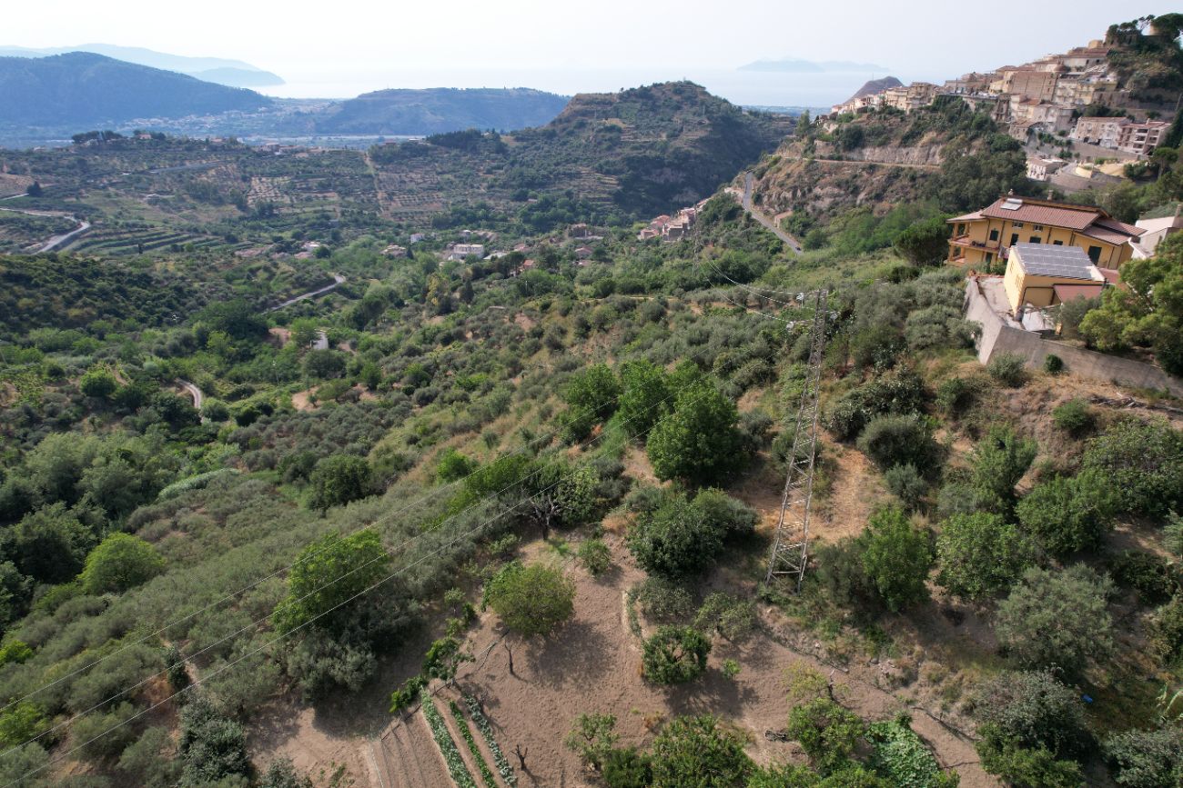 The hills and terraces above Castroreale, with the Aeolian sea beyond
