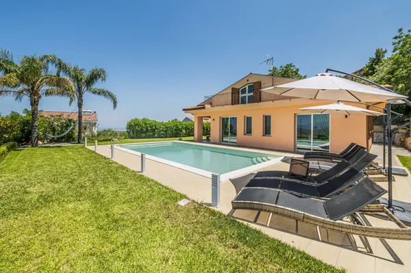 The villa — pool and garden